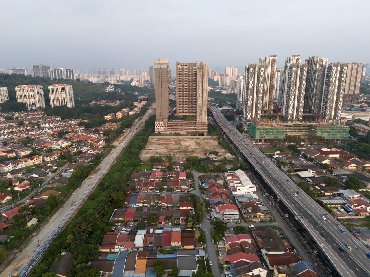 M Aurora site by day on Old Klang Road, bracketed by the KTM rail line and highway, Kuala Lumpur